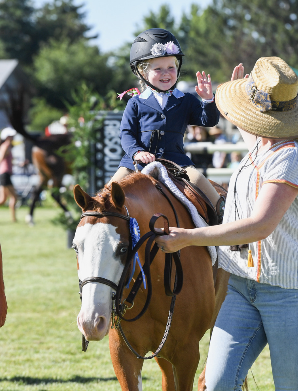 Jeanette and daughter Aggie share a high five after a successful lead-line performance; photo by GrandPix